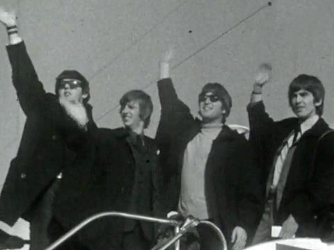 The Beatles, Paul McCartney, Ringo Starr, John Lennon and George Harrison, wave to crowds at the airport before boarding a plane to leave Sydney in June 1964.