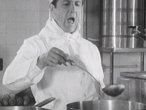 Bobby Limb as the singing chef stands over a large cauldron of soup