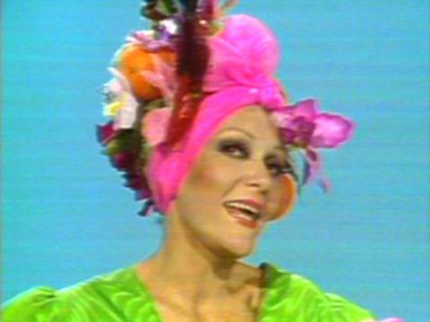 Jeanne Little in close-up. She is dressed in a flourescent head dress.