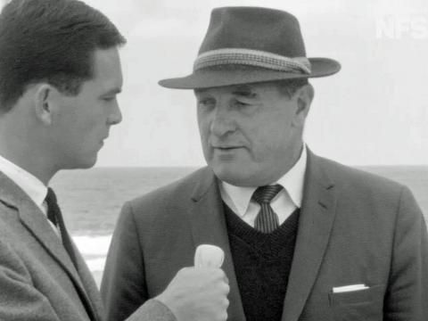 News reporter Ian Ross interviewing a police detective at Wanda Beach in Sydney's south in 1965.