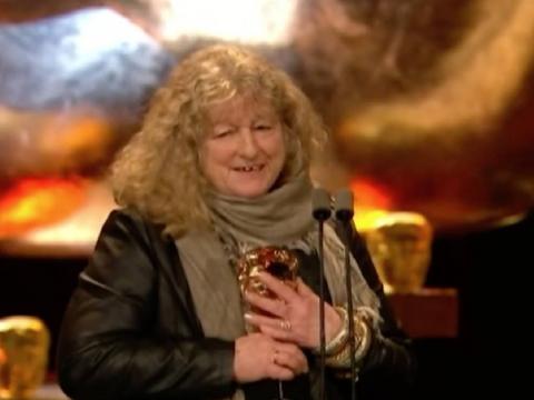 Costume designer Jenny Beavan holding her award for Best Costume Design for Mad Max: Fury Road at the BAFTA Awards