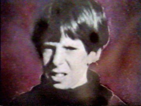 Close up of a young boy named Terry Floyd who went missing in 1975 from his home town in rural Victoria. He has short brown hair and is wearing a sweater.