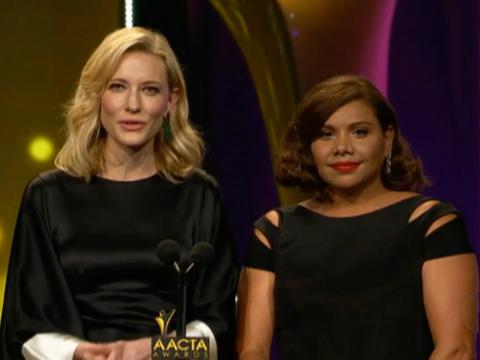 Actors Cate Blanchett and Deborah Mailman pictured from waist up standing side by side presenting at an awards ceremony