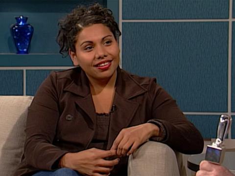 Actor Deborah Mailman seated on a couch in a tv studio