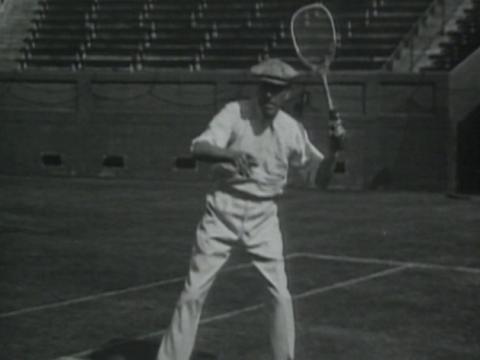Norman Brookes playng tennis.