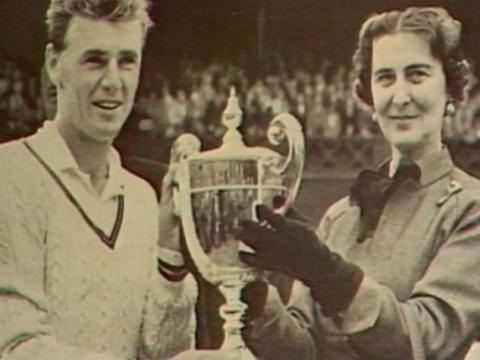 Frank Sedgman receiving the championship trophy.