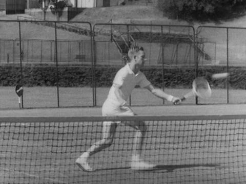 Rod Laver playing a forehand tennis shot.