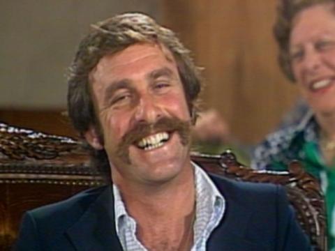 Close up of John Newcombe laughing