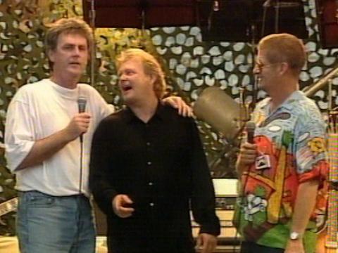 John Farnham, centre, wearing black shirt stands on stage with comedians Roy and HG during the Dili Concert For the Troops in East Timor.