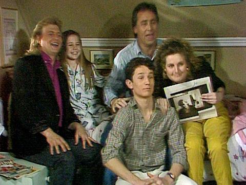 John Farnham with Kate Ritchie (as Sally Fletcher) and other cast members in a scene from TV soap Home and Away. 