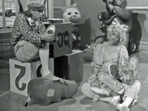 John Farnham and Colleen Hewett dressed up as 5 year old kids and surrounded by toys in a sketch from their variety show 'It's Magic'.
