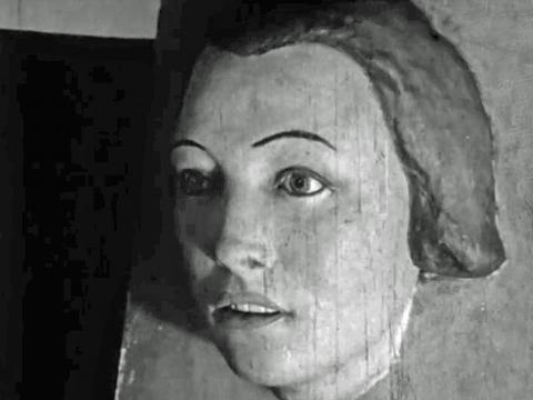 A painted plaster cast of a young woman's face. It is the face of the murder victim known as 'the pyjama girl'