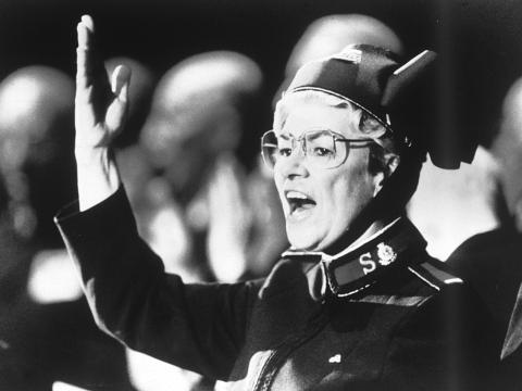 Eva Burrows wearing a Salvation Army uniform and singing