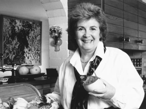 Margaret Fulton in a kitchen holdng a lemon