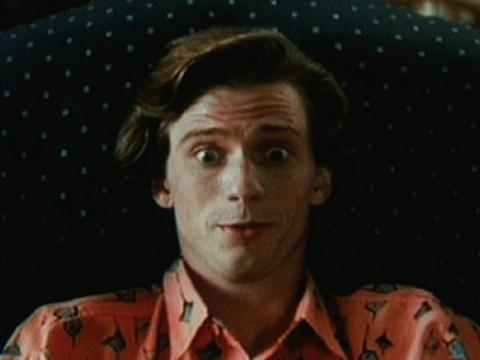Head and shoulders shot of a young man looking surprised