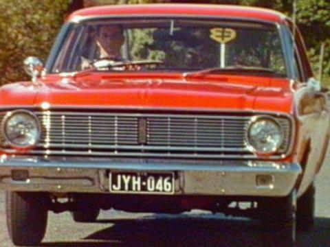 A red vintage XT Falcon seen from the front with the chrome front bumper featuring prominantly.