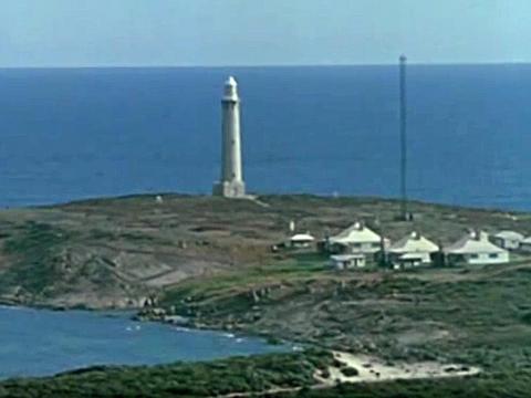 Part of the coastline at the south-west corner of Western Australia. The Leeuwin lighthouse is pictured in the distance.