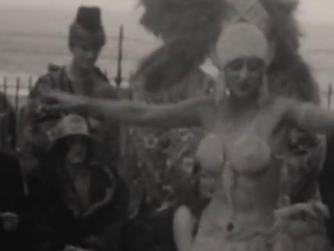 A female circus performer dances in front of others