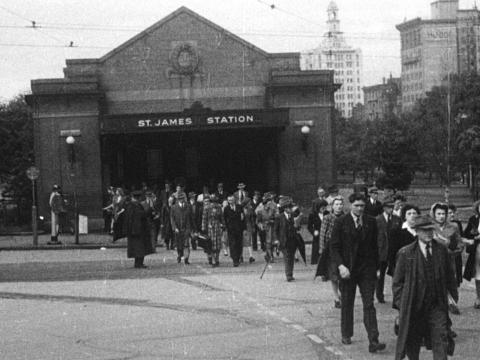 Black and white still of the front of St James Station in Sydney from the street.
