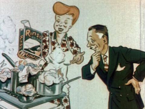 Shot from animated commercial showing a woman wearing an apron and holding a box of washing powder while a middle-aged man in a suit looks on.