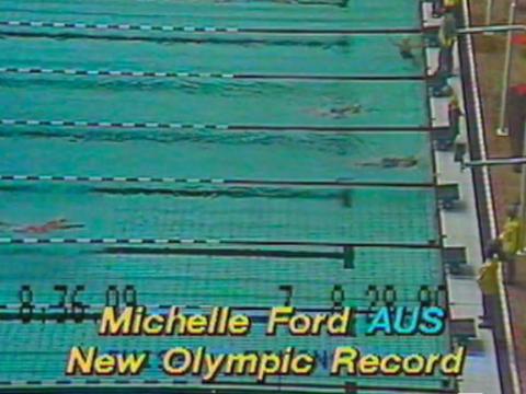 Looking down at the pool as Michelle Ford wins. Text reads: Michelle Ford. AUS. New Olympic Record