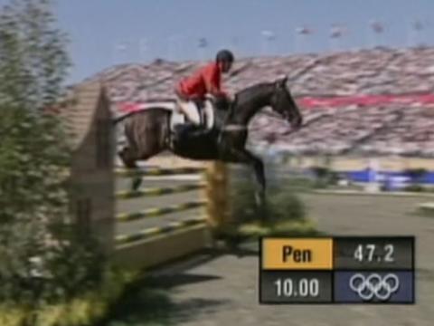 A horse and rider leaping over a barrier during an equestrian event