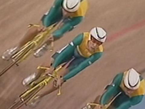 Three members of the Australian pursuit cycling team rounding the velodrome bend