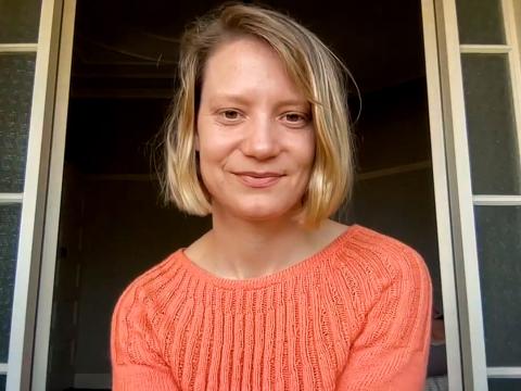 Head and shoulders shot of actor Mia Wasikowska smiling at camera