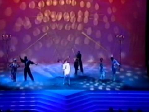 An overhead shot of John Paul Young on stage, flanked by dancers, performing Love is in the Air at the 1992 AFI Awards ceremony