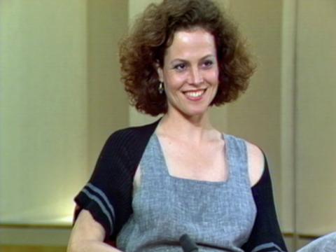 Actor Sigourney Weaver smiles as she is being interviewed on a studio set.
