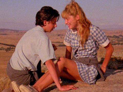 High school students Noah Taylor and Loene Carmen talk intimately outside in a scene from the film The Year My Voice Broke