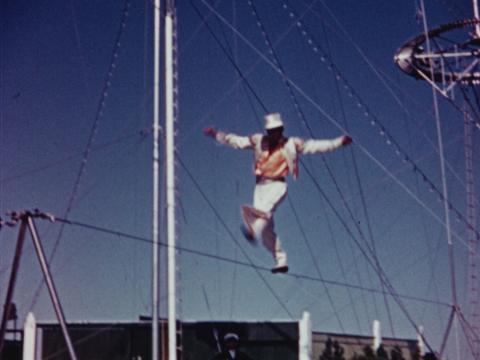 A man performing on a tight rope.