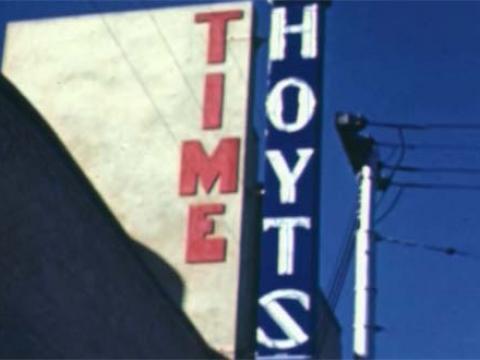 The side of a cinema building in the 1940s with the sign 'Time Hoyts'