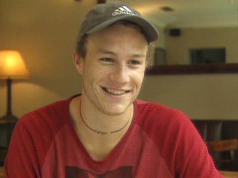 Actor Heath Ledger is smiling as he is interviewed. 