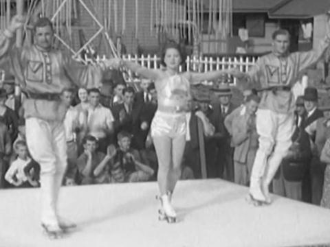 Three Russian skaters finish their circus routine and accept applause