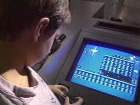 Young boy playing a video game.