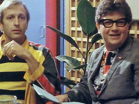 Comedian Graham Chapman (of Monty Python fame) and Wonder World reporter Jonathan Coleman both pictured from waist up in a TV interview setting