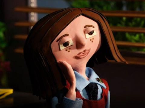 Claymation still of a young schoolgirl looking sad.