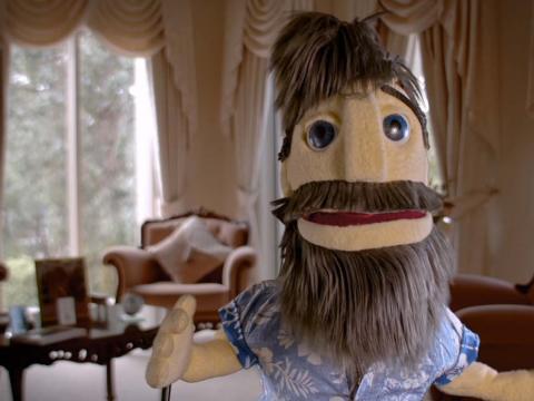 Close up of a male puppet with a beard
