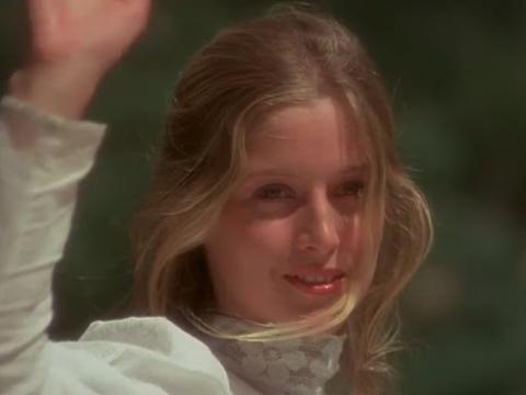 A young girl wearing white waves