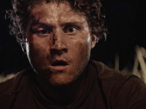 Close up of man's shocked face covered in dirt