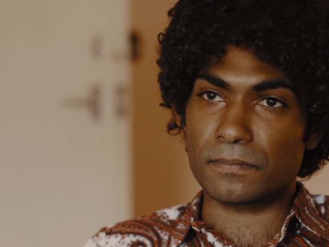Close-up of a young Indigenous man crying