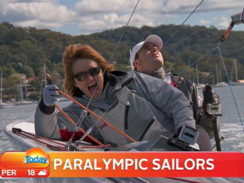 Paralympic sailors Leisl Tesch and Daniel Fitzgibbon sailing on Sydney Harbour. Tesch is giving a thumbs up and looks like she is having a great time. Fitzgibbon is looking up at a sail.
