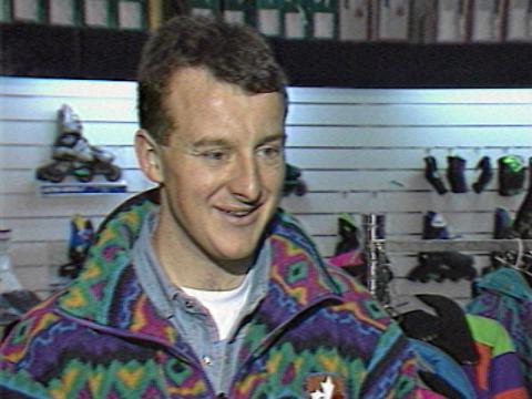 Paralympic skiier Michael Milton is being interviewed. He is smiling. He is wearing ski gear and is at a ski shop.