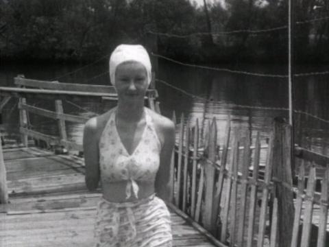 Beryl Morrin, who had both her arms amputated after a shark attack, stands on a pier
