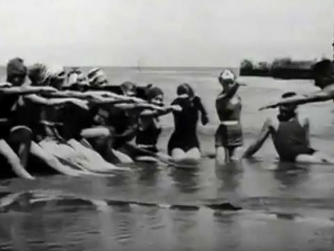 Well known swimming instructor, Frenchman Alex Sauter, at St Kilda beach teaching local ballerinas how to swim.