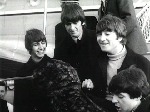 The Beatles disembark a plane in Sydney