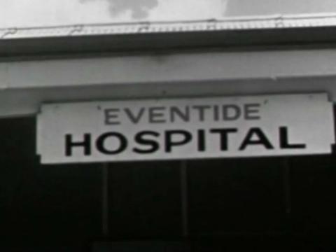 Close up of a sign on a building that reads 'Eventide Hospital', circa 1950.