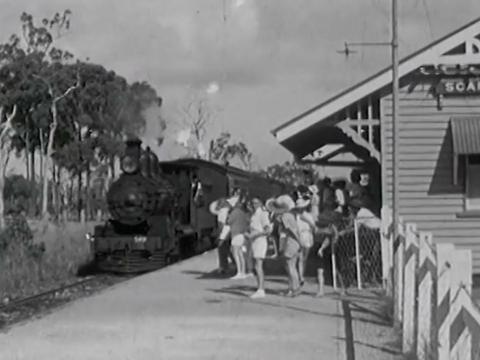 A train arrives at Scarness railway station in Brisbane, taking passengers to the annual Maryborough railway workers' picnic.
