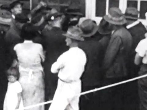 People waiting outside a building in Brisbane to receive food parcels, circa 1939